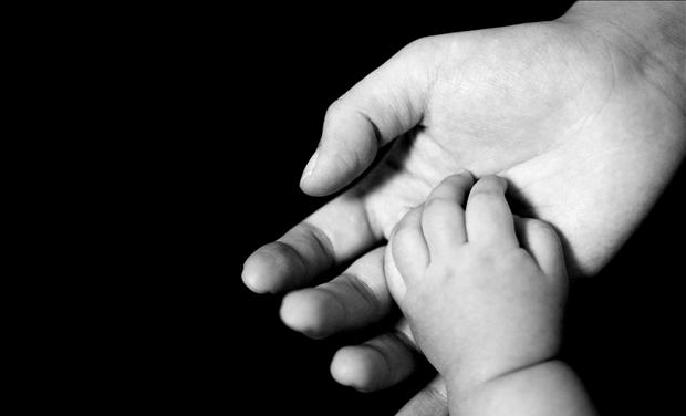 Newborn baby pro life month mother and baby hands