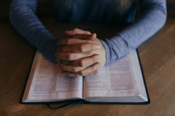pray bible stock patrick fore unsplash