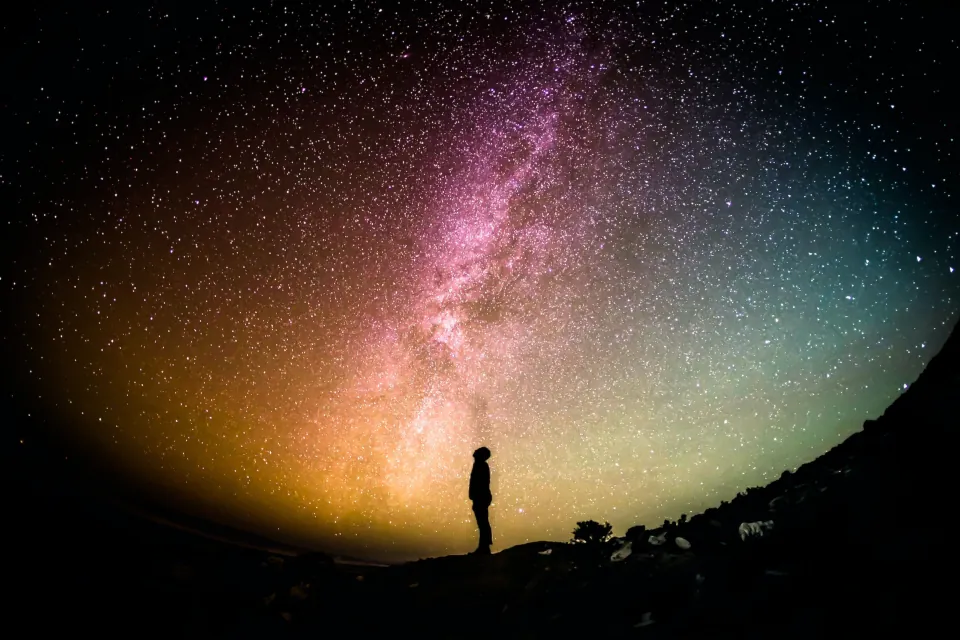 Silhouette of man against universe stock by Greg Rakozy on unsplash