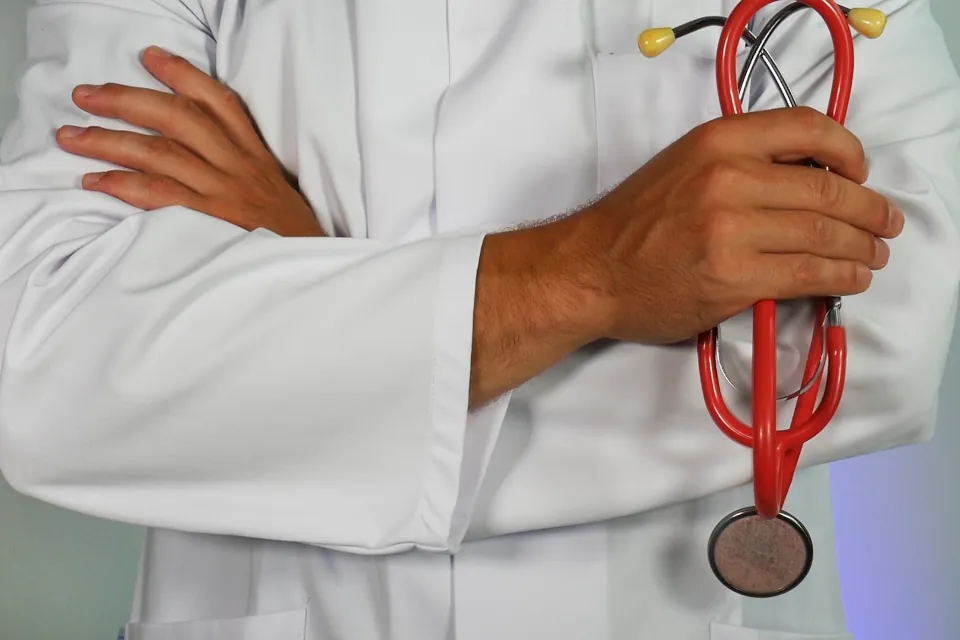 Stock photo of Doctor holding red stethoscope by Online Marketing on unsplash