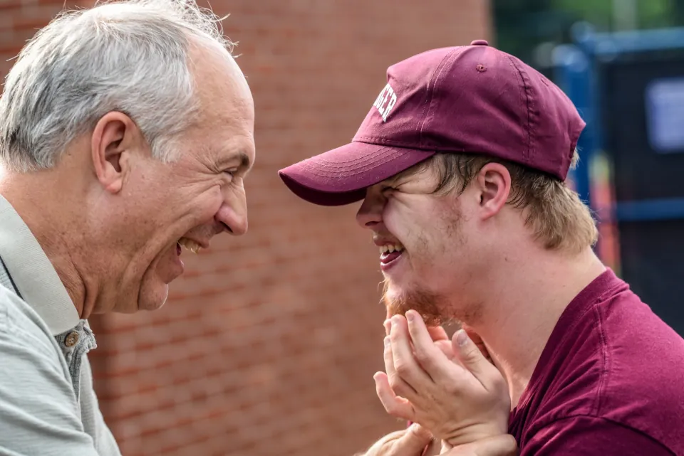 Stock photo of old man and differently-abled man with down syndrome by Nathan Anderson on unsplash.