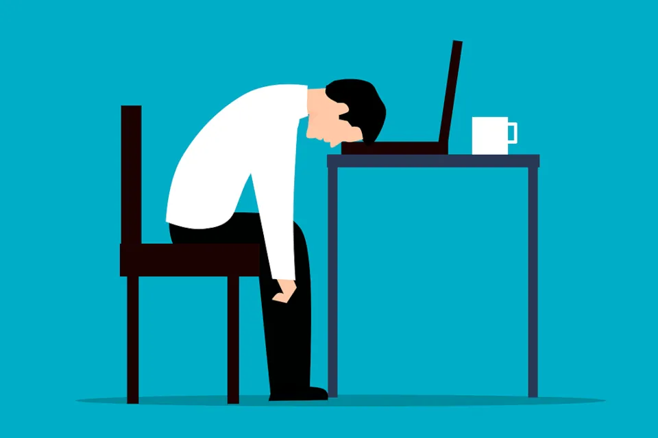 Stock image of an employee tired/sleeping at the desk