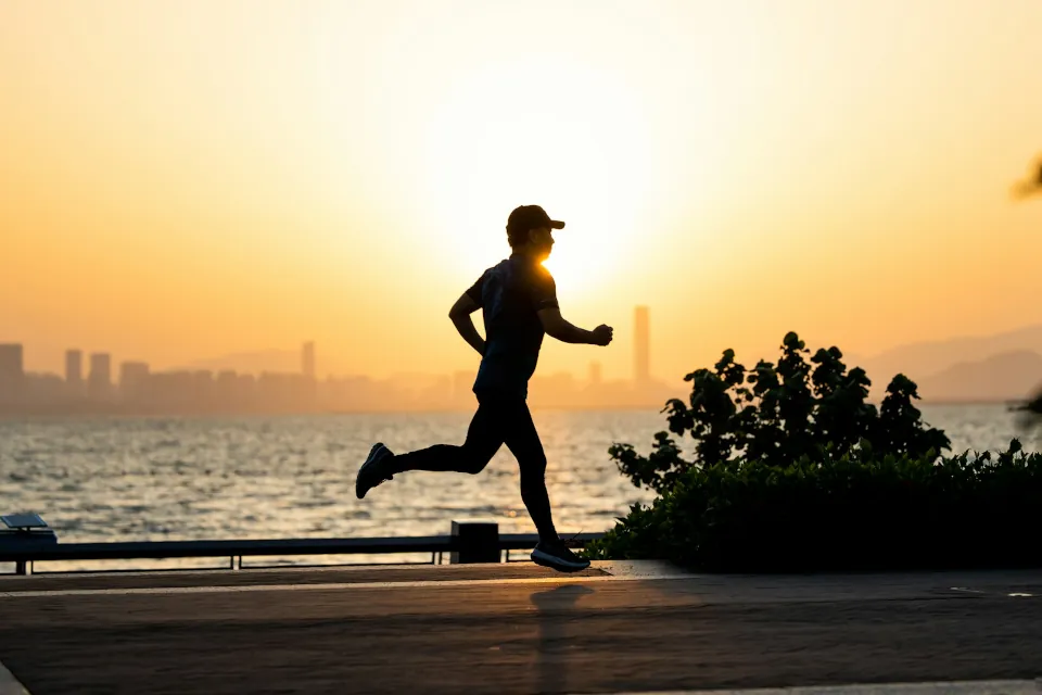 stock photo of a man jogging running by Shengpengpeng Cai on Unsplash