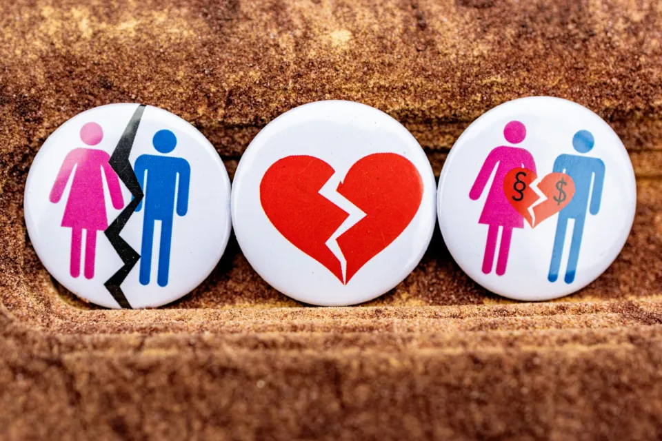 stock photo of three buttons depicting a broken heart, separation of a man and a woman