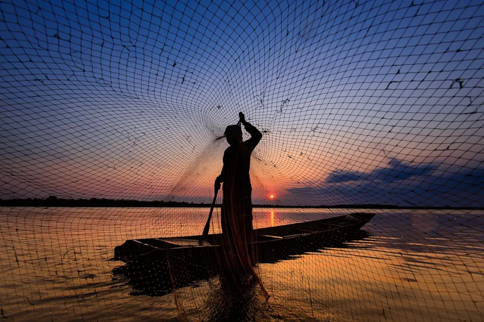 Stock Photo of a man fishing in a lake by chanwit whanset from Pixabay
