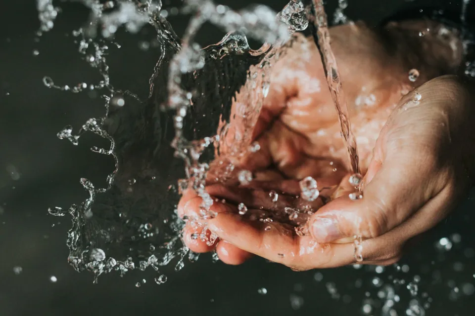 Stock Photo of water splashing on hands by Nathan Dumlao on Unsplash