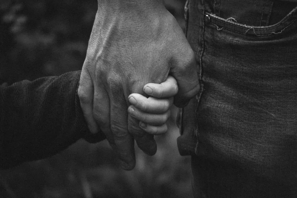 stock photo of a father holding his child's hand by Susanne Moberg on Pexels
