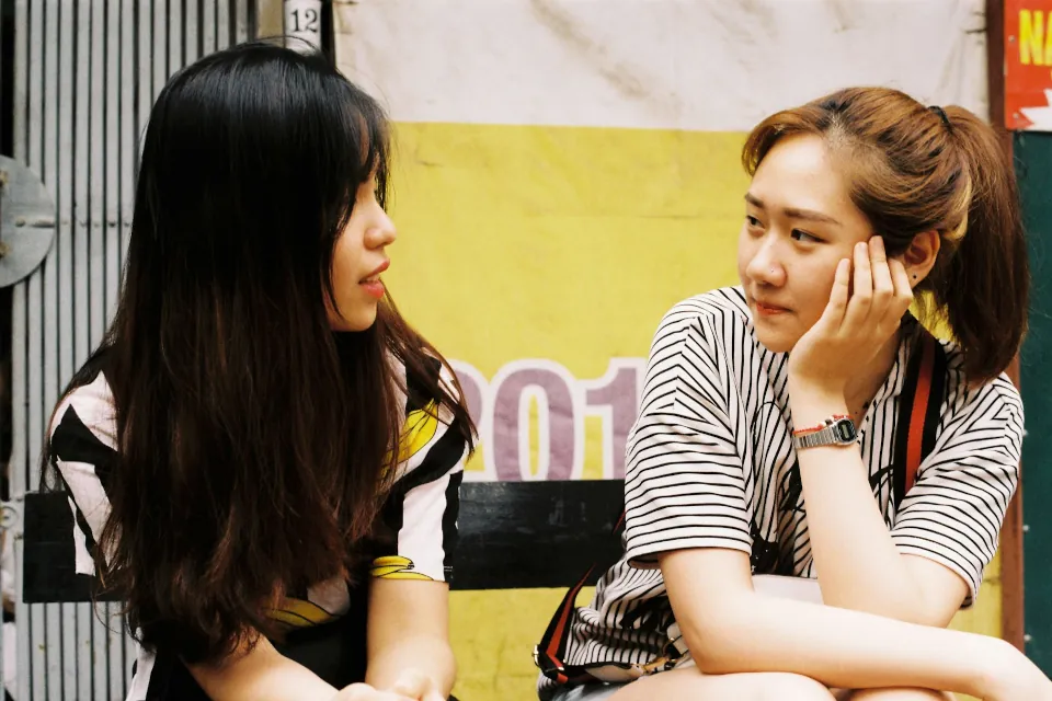 stock photo of two women talking by Trung Thanh on Unsplash
